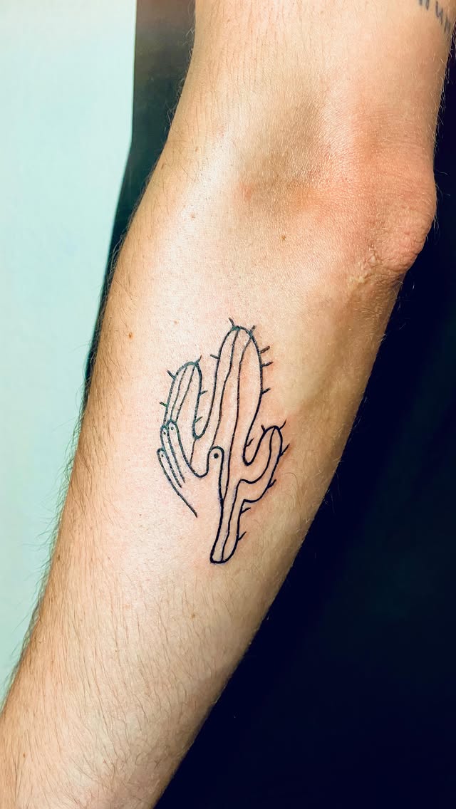 Minimalist fine line cactus tattoo on forearm