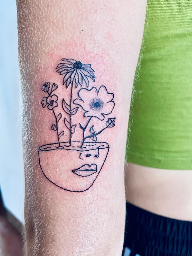 Fine line floral face vase tattoo